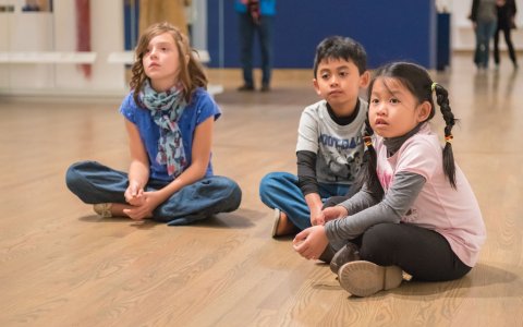 Children sitting on the floor in the galleries. 