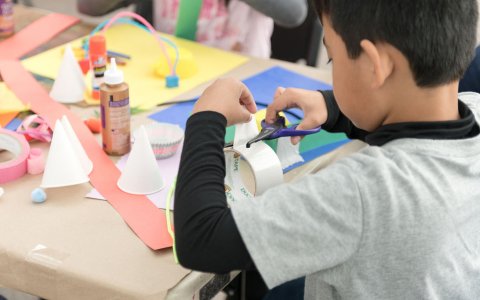 A young boy making art. 